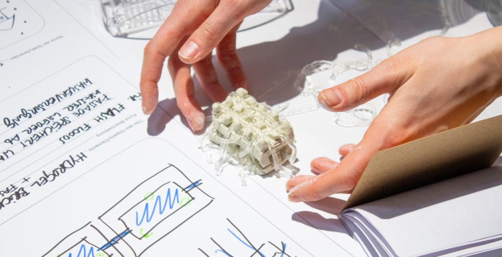 Hands placing a custom material on a drawing